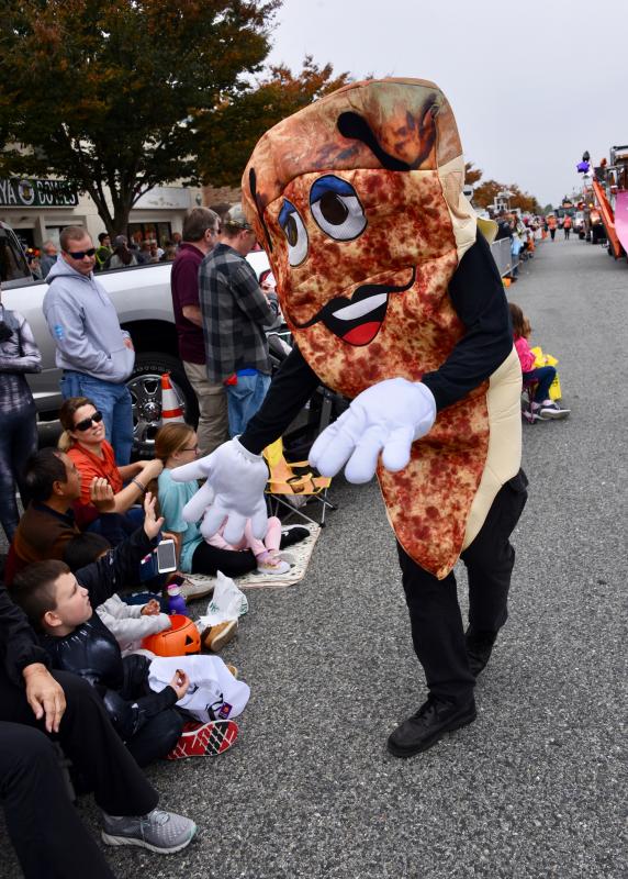 Yes, that’s a large pizza slice walking on Rehoboth Avenue giving high-fives during the parade. RON MACARTHUR PHOTO
