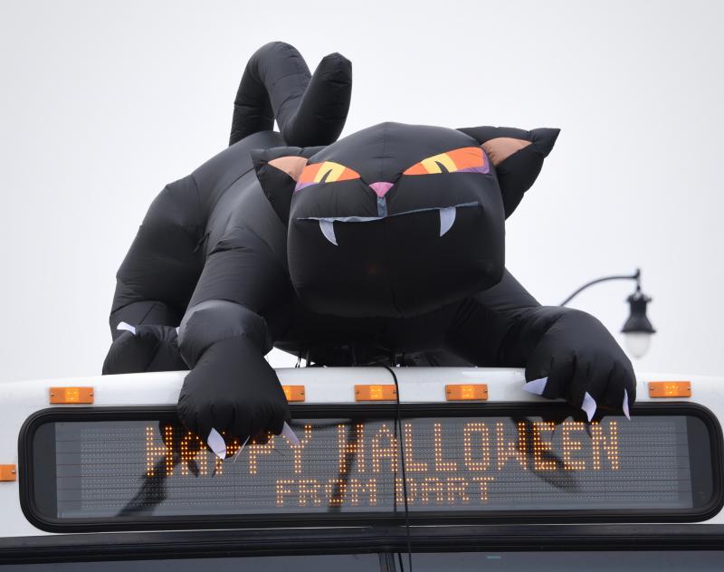 A menacing inflatable cat sits atop a DART bus as he navigates the parade route. RON MACARTHUR PHOTO