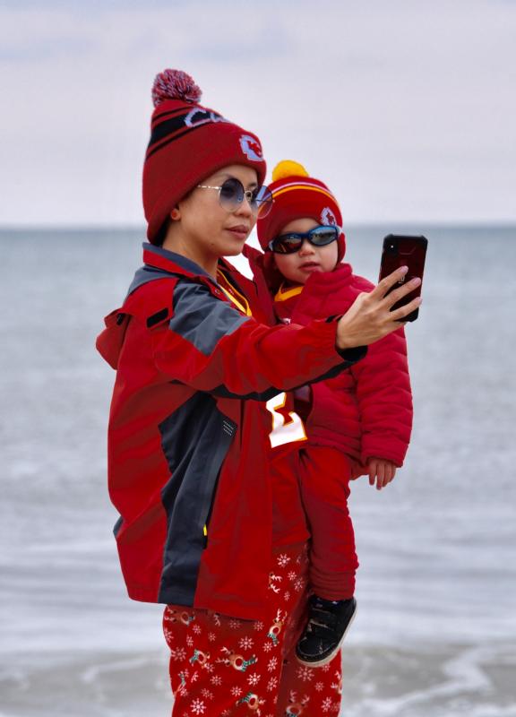 Kansas City Chiefs fans Thea and Trevor Ward of Dover take a selfie along the shoreline. RON MACARTHUR PHOTO
