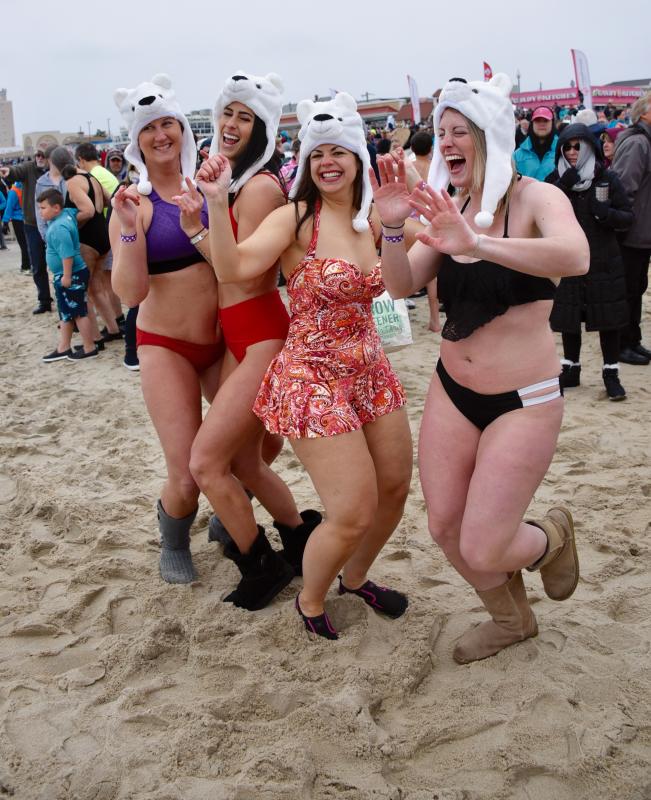 Delaware friends do a happy dance to keep warm prior to the plunge. They are (l-r) Monica Bayless, Hannah Dukes, Cinzia Lombardo and Nicole Francis. RON MACARTHUR PHOTO