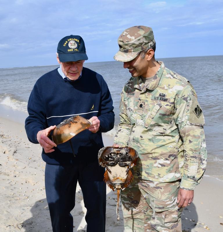 U.S. Sen. Tom Carper, left, and U.S. Army Corps of Engineers Lt. Col. Ramon Brigantti discuss the importance of maintaining a viable beach habitat for horseshoe crabs.