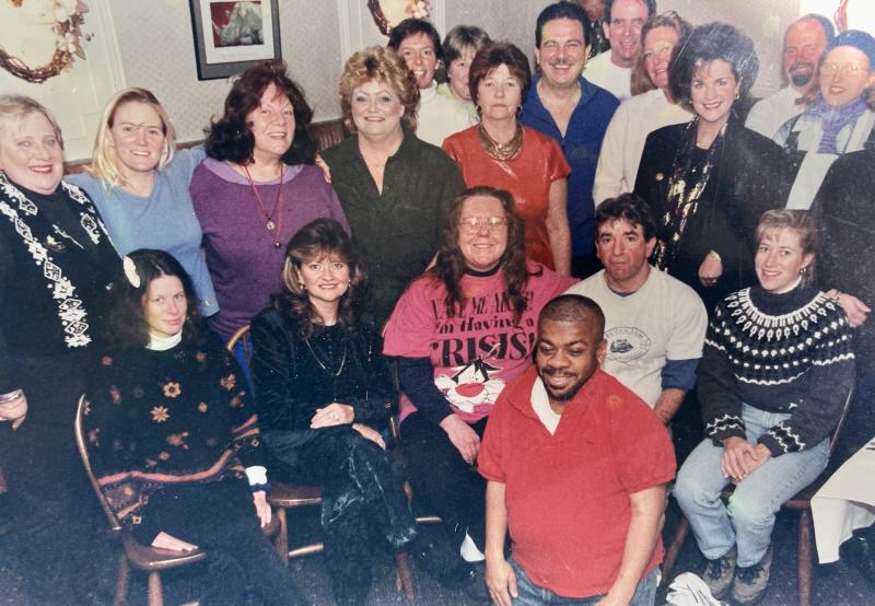 Krasnoff, seated in white T-shirt), and his staff gathered for a photo on Kupchick’s final day, Jan. 11, 2001. Sherman Carter is kneeling in front. Many of these employees worked for Krasnoff for more than a decade.