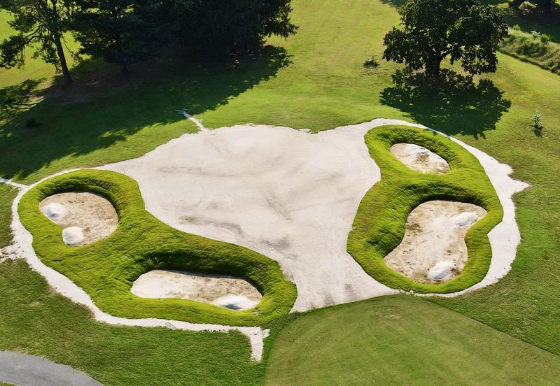The newly rebuilt ninth hole at Southern Delaware Golf Club in Milford. Zoysia sod in the bunkers replaced the high sand walls that were part of the prior design. This change reduces the maintenance burden while still presenting real challenges to the golfers who land in the bunkers. Piles of bunker sand are in place, ready to be spread along the bottoms. NICK ROTH PHOTO