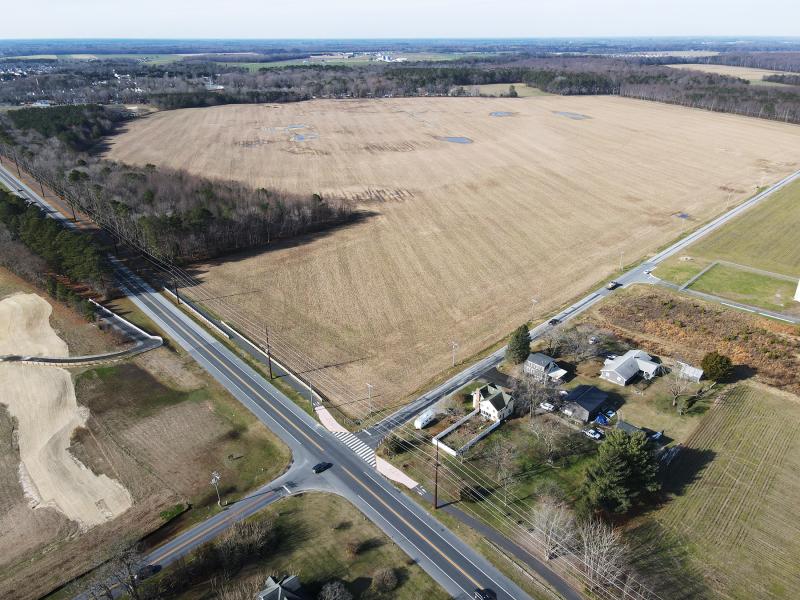 The proposed Cool Spring Crossing project includes all of the farmland and most of the woods shown in the photo. The property is along Route 9 starting at the Cool Spring Road intersection. NICK ROTH PHOTO