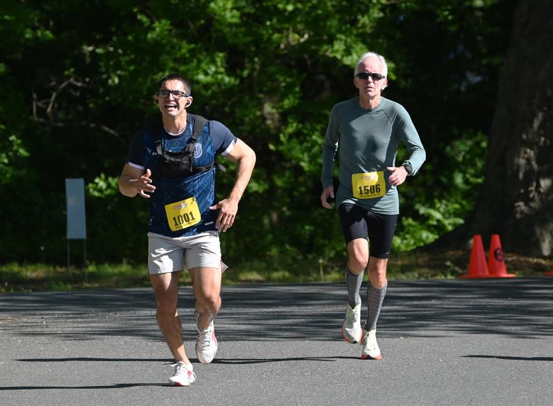 Luis Xavier Aguirre, 28, of Georgetown, left, and Tim Young, 64, of Rehoboth Beach hit the final stretch through Nassau Commons.