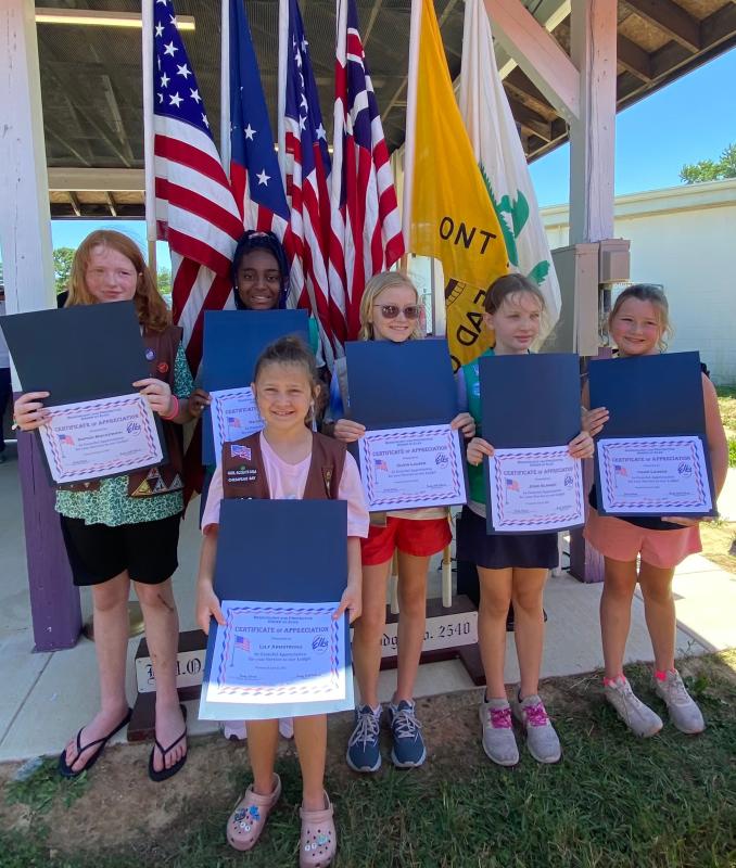 Certificates of appreciation were presented to each of the hardworking girls of Girl Scout Troop 499 of Georgetown, standing before the flags each girl presented during the ceremony. Shown are (l-r) Sophia Mockewich, Na'hera Henry, Lily Armstrong, Olivia Lauser, Josie Schmidt and Page Lauser.