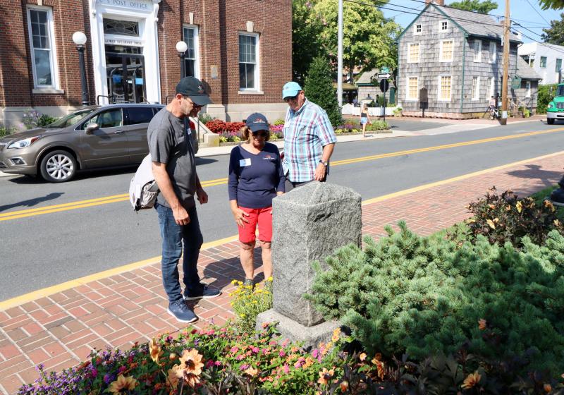 Alain Cappelle, left, learns about the bombardment of Lewes from Lewes in Bloom volunteers Cindy DeEmedio and Dave Beck.