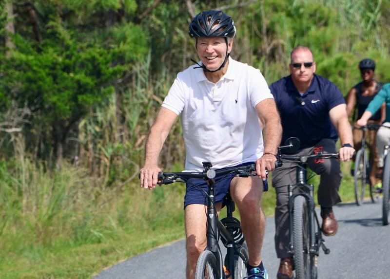 President Joe Biden returns from a bike ride on the Gordons Pond Trail. The president smiled, but did not stop to sign the Moskowitz’s photo.