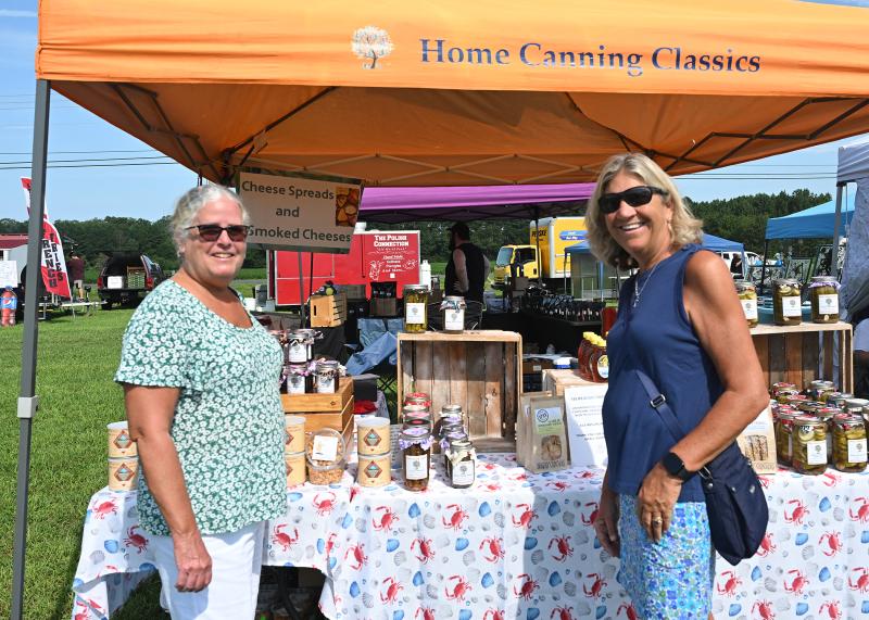 Peggy McClatchey, left, and Cheryl Carey check out the Home Canning Classics tent owned by Louise Ryan.