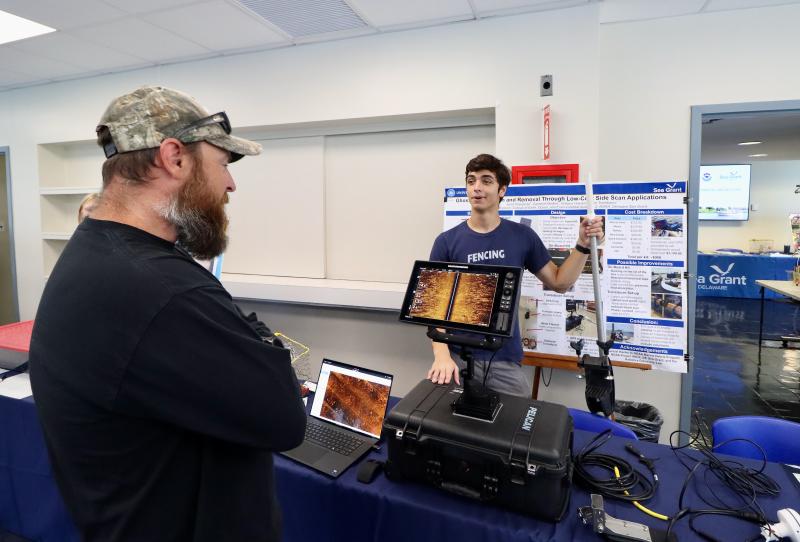 Sean Bennett of DNREC’s Division of Watershed Stewardship, left, learns about side-scan sonar from Jared Wierzbicki, a University of Delaware student who works in the Center for Composite Materials. Bennett said DNREC has just started using the sonar system.