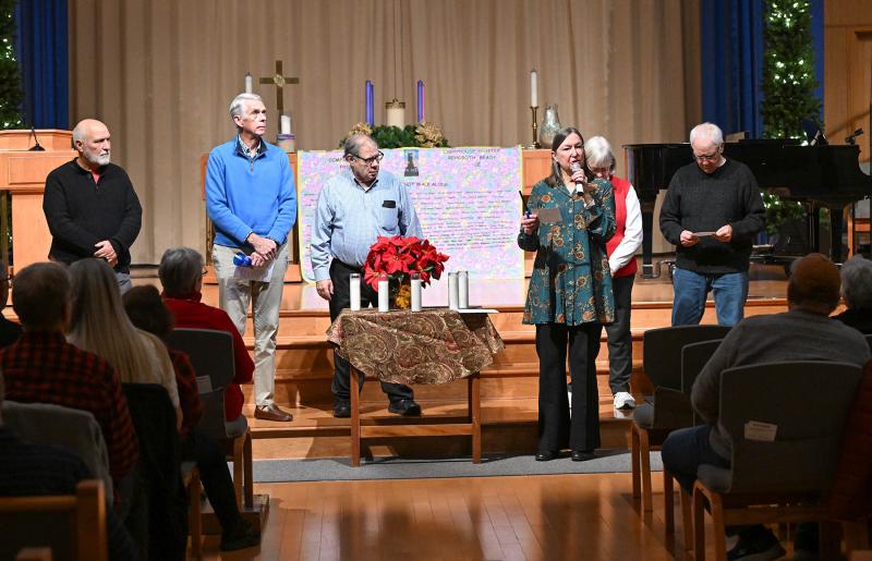 Jill Hicks of Compassionate Friends performs the lighting of the candles. Shown reading are (l-r) Fred Taddeo, Robert Kennedy, Al Liebeskind, Cathy Robinson and Skipp Robinson.