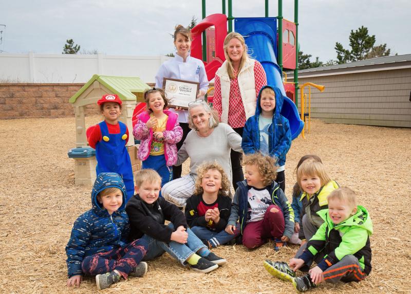 Paula Baker holds a certificate of appreciation from the U.S. Department of Agriculture in 2019. She is surrounded by some of the children and counselors at CBH. Baker received the honor for her dedication to healthy and nutritious meals she created for children. PHOTO COURTESY OF PAULA BAKER