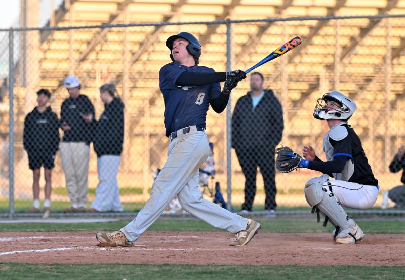 Jaxon Clampitt watches as his sac fly goes deep into left field to easily score Jase Mitchell and give the Vikings a 1-0 victory.