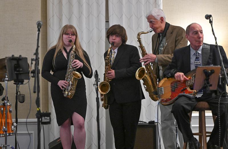 Cape Henlopen band members Julia Burrell and Reed Williamson sit in on sax with 5th Avenue band members Monte Wisbrock on saxophone and Jeff Cooper on bass.