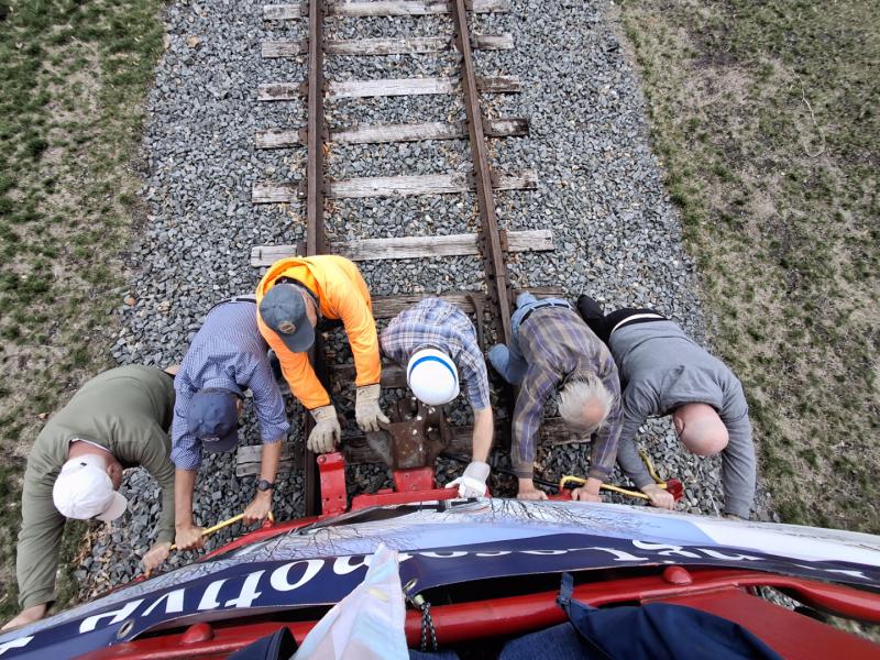 An overhead shot shows Lewes Junction Railroad and Bridge Association volunteers pushing the red caboose down the track in Stango Park March 29. Sen. Russ Huxtable even joined what they called the “Big Shove.” The caboose was moved to make room for a coal tender that will soon be placed on the track. SUBMITTED PHOTOS